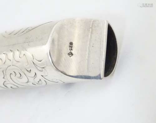 A silver whistle with acanthus scroll decoration 2 1/2