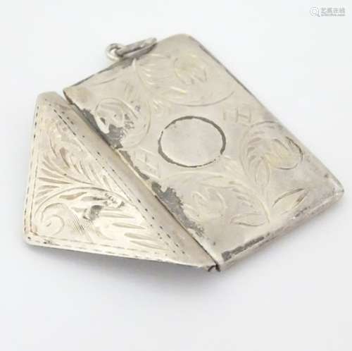 A white metal double stamp case of envelope form with engraved decoration.