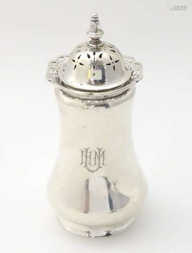 A silver sugar caster / dredger / muffineer with fret work decoration to top rim.