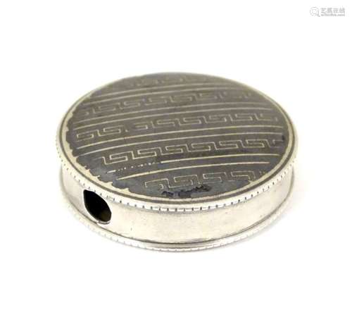 A French silver pill box of circular form with niello decoration.