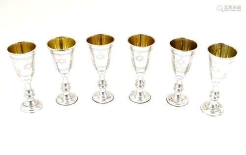 A set of 6 silver kiddush cups with engraved decoration and gilded interior.