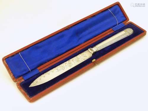 A cased silver plated bread / cake knife.