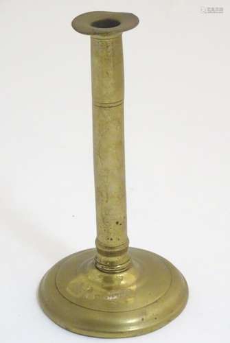 A 19thC brass candlestick with a spun base. Approx.