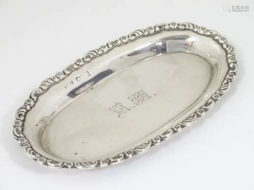 A silver pin dish of oval form. Hallmarked London 1908 maker Mappin & Webb Ltd.