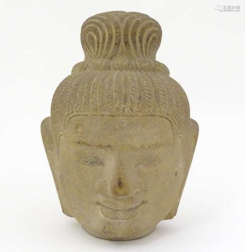 A model of a sandstone Buddha head with elongated earlobes and stylised plaited hair. Approx.