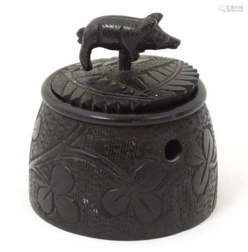 An Irish bog oak pot and cover with carved shamrock and harp decoration to the body of the pot,