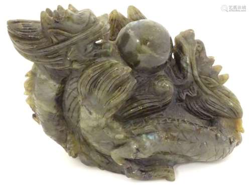 A Chinese dark spinach green coloured jade sculpture carved with 2 dragons and pearl of wisdom with