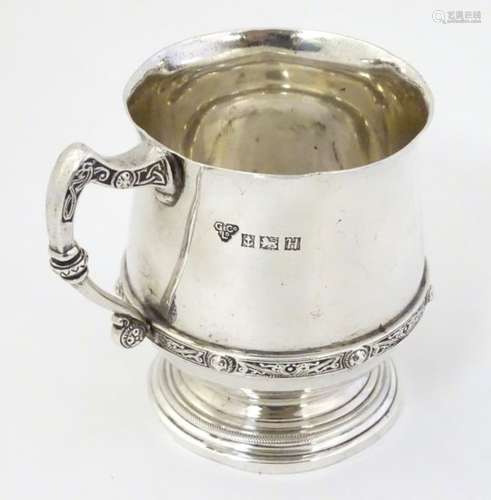 A silver tankard with banded Celtic decoration Hallmarked Birmingham 1957 maker Garrard & Co.