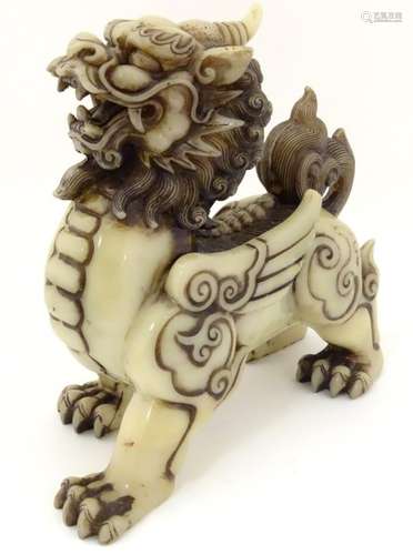 A carved Chinese cream coloured jade like winged luduan style creature with 4 toes 10