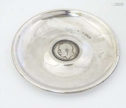 A silver pin dish set with Geo V one shilling coin to centre .