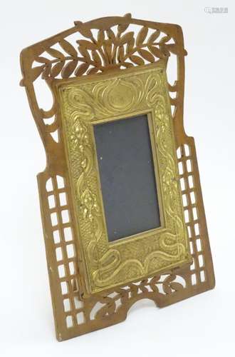 An easel back photo frame with a beech surround with fretwork decoration,