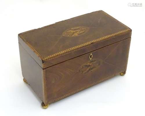 An 18thC Sheraton inlaid flame mahogany two division tea caddy, with turned spherical feet.