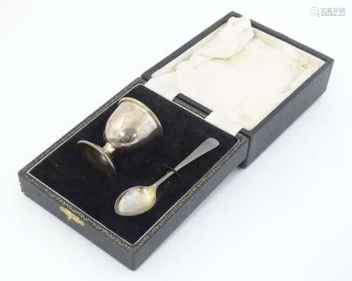 A silver egg cup and spoon hallmarked Birmingham 1954 maker B& Co. Cased.