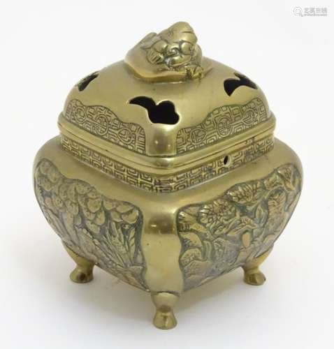 A Chinese brass censer of squared form with chased decoration to side panels and having 4 hoof