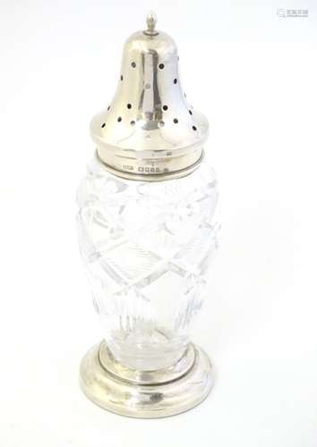 A cut glass sugar shaker / caster / muffineer with silver top hallmarked London 1935 with jubilee