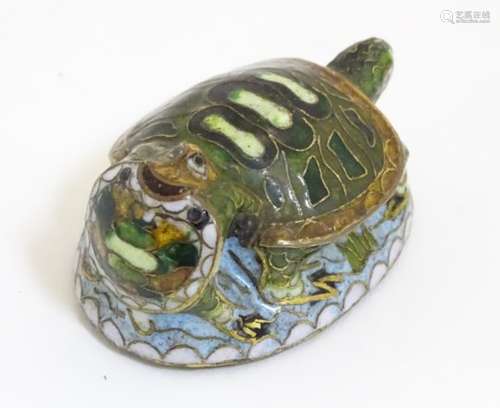 An Oriental cloisonne image of 2 turtles.