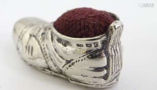 A novelty silver pin cushion formed as a boot.