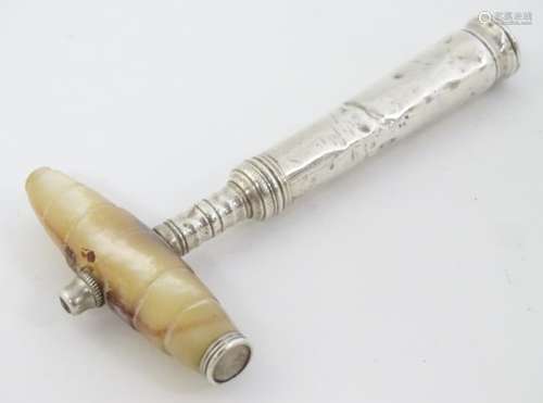 A white metal corkscrew with mother of pearl handle.