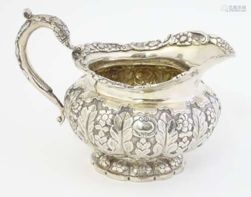 A 19thC Irish silver jug with acanthus and floral decoration hallmarked Dublin 1828 4 3/4