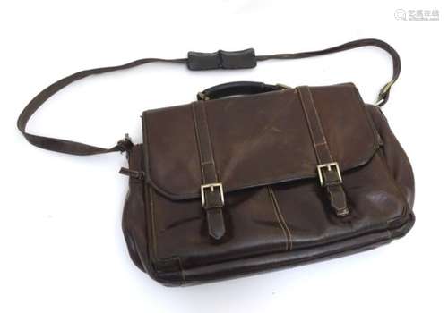 A late 20thC leather satchel with shoulder strap and various zip compartments,