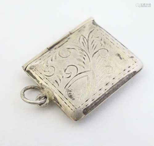 A silver stamp case of envelope form with engraved decoration.