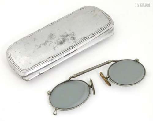 A cased pair of Edwardian pince nez spectacles / glasses with a nickel frame, telescopic bridge,