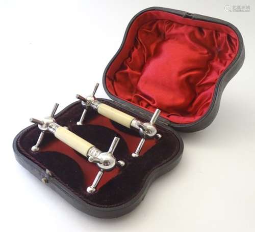 A cased pair of silver and ivory knife rests hallmarked Sheffield 1898 maker Lee & Wigfull.