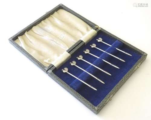 6 silver cocktail sticks surmounted by cockerel.