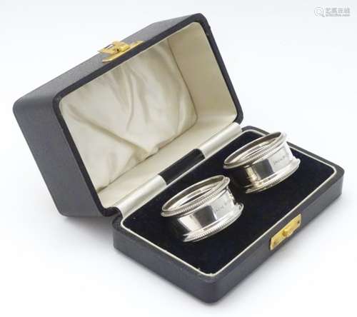 A cased pair of napkin rings hallmarked London 1935 maker EB&Co CONDITION: Please