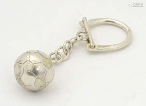 A silver and silver plate key ring with football fob.