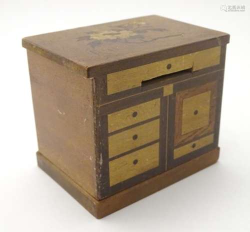 A 19thC Continental moneybox, formed as a miniature cupboard, with various contrasting inlays,