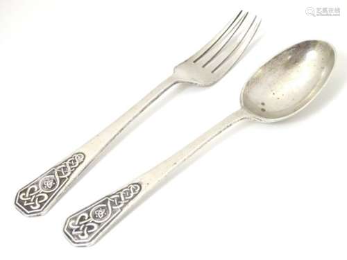 A silver christening spoon and fork with Celtic decoration to handles.