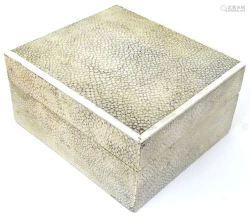 An early 20thC shagreen box of rectangular form with wood lined interior and banding around the top.