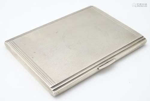 An Art Deco silver cigarette case with engine turned decoration hallmarked Birmingham 1937 maker D