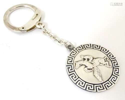 A silver key ring with horse to centre within a greek key border CONDITION: Please