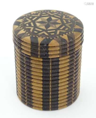 A Tunbridge 19thC stick ware parquetry games counter box of cylindrical form with screw lid.