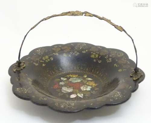 A Victorian papier mache cake basket with swing handle with gilt foliate decoration,