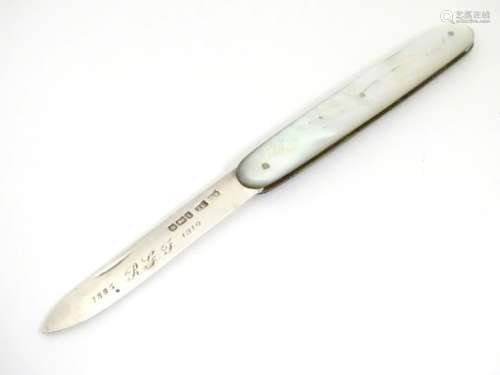 A silver pen knife with mother of pearl handle having engraved floral decoration.