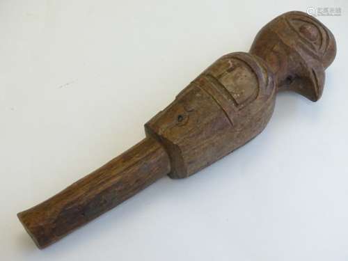 A Native American folk art carved hardwood tip staff, the top modelled as a bird with adze detail.