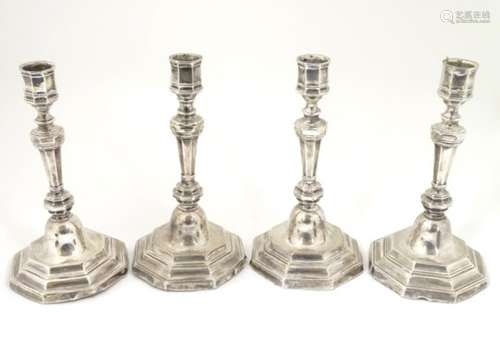 A set of 4 silver candlesticks hallmarked Birmingham 1910 maker Alexander Clark Manufacturing Co.