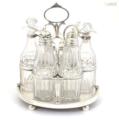 A Geo III silver cruet stand hallmarked London 1806 with 5 cut glass cruet bottle. The whole approx.