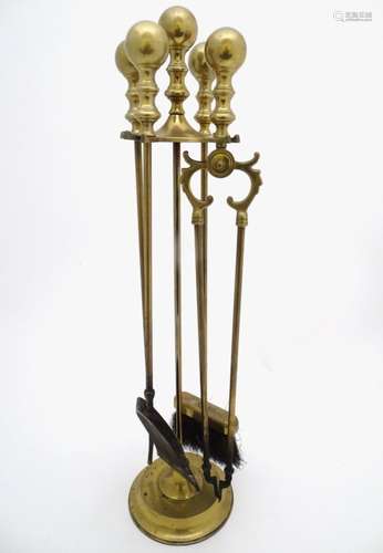 An Early to Mid 20thC set of fire tools, mounted on a stand.