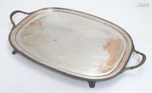 A silver plate tray with twin handles and four feet. 24 12