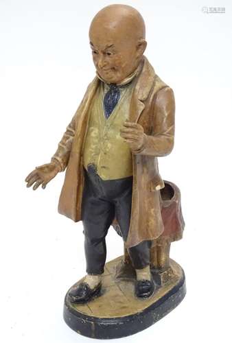 A Victorian terracotta figure of a bald man in a cravat and waistcoat,