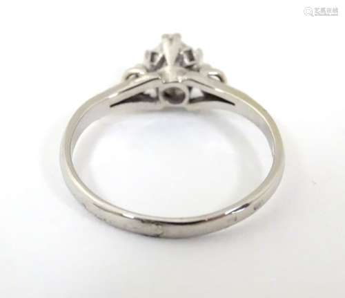 A white gold ring set with central diamond solitaire. Approx. 0.