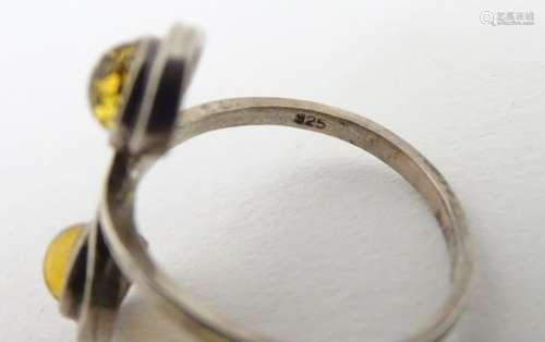 A silver ring set with amber cabochon CONDITION: Please Note - we do not make