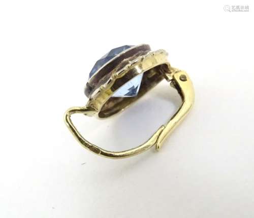 A pair of 9ct gold earrings set with facet cut aquamarines,