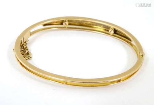 A 9ct gold bangle bracelet set with graduated seed pearls CONDITION: Please Note -