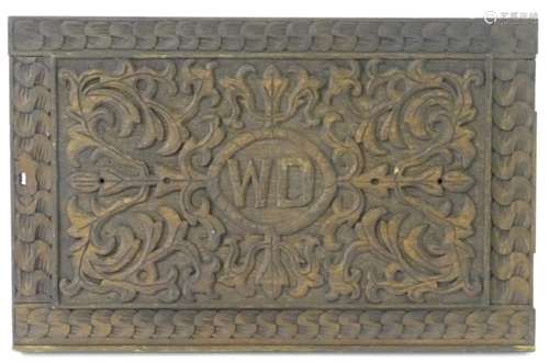 A late 19thC / early 20thC oak panel with carved decoration and the letters 'W D' to the centre.