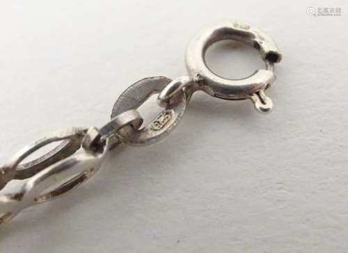 A silver bracelet with link and twist decoration. 7” long.